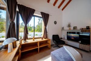 a living room with a large window and a television at Villa Plitvina in Vela Luka +54 photos