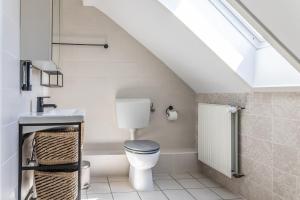 a bathroom with a toilet and a sink at 50112 Ferienwohnung "Coco" in Carolinensiel +3 photos
