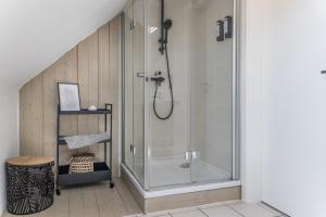 a shower in a bathroom with a glass shower stall at 50112 Ferienwohnung "Coco" in Carolinensiel