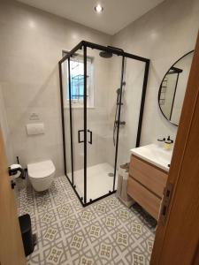 a bathroom with a shower and a toilet and a sink at Ema & Jakov in Sreser +16 photos