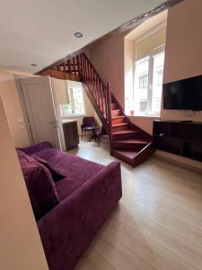a living room with a couch and a staircase at Chorni vivtsi in Chernivtsi +31 photos