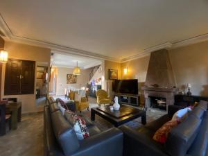 a large living room with couches and a fireplace at Villa Bouchra in Marrakesh