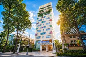 a tall white building with a sign on it at G8 Center Hotel Saigon in Ho Chi Minh City