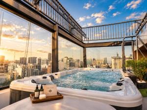 a hot tub on the roof of a building with a view at G8 Center Hotel Saigon in Ho Chi Minh City