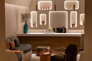 a restaurant with a table and chairs and lights at Résidence & Spa Le Prince Régent in Paris