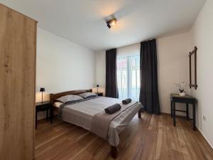 a bedroom with a bed and a large window at Apartment Ana Pool Residence in Preko +21 photos