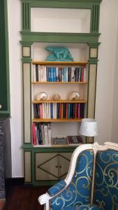 a book shelf filled with books next to a chair at LA LANDE in Pleyber-Christ