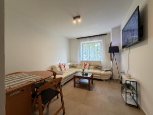 a living room with a couch and a table at Apartment Ana Pool Residence in Preko