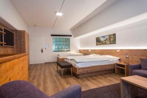 A bed or beds in a room at Zermatt Budget Rooms
