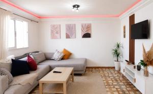a living room with a couch and a table at Petit villa centre harhoura Près de la plage in Temara