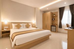 a bedroom with a large bed in a room at Son Mi Hotel in Ho Chi Minh City