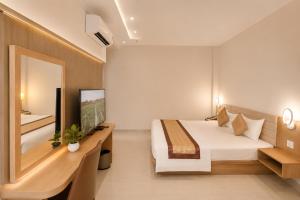 a hotel room with a bed and a mirror at Son Mi Hotel in Ho Chi Minh City