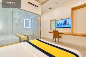 a bedroom with a bed and a desk and a tv at Son Mi Hotel in Ho Chi Minh City