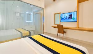 a bedroom with a bed and a desk and a tv at Son Mi Hotel in Ho Chi Minh City