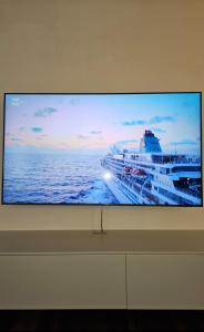 a large tv screen with a cruise ship at Antica Dimora Confine in Mira