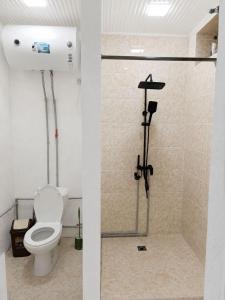 a bathroom with a toilet and a shower stall at Sho Hostel in Khorugh