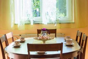a dining room table with a tea pot and cups on it at Apartments Pepi in Mali Lošinj