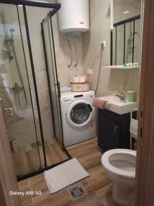 a bathroom with a washing machine and a washer at Nido Apartman in Kotor