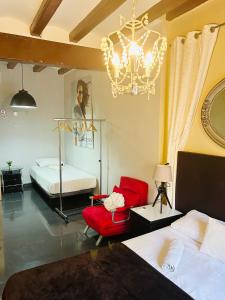 a bedroom with two beds and a chandelier at Font 1 Circo Romano in Tarragona +19 photos
