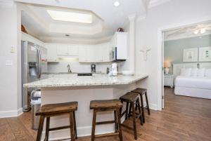 a kitchen with a counter and stools in a room at Phoenix on the Bay 1109 condo in Orange Beach