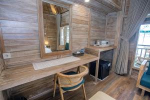a room with a vanity with a mirror and a chair at The Old Island Huts in Nusa Lembongan +28 photos