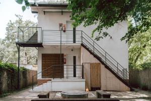 a house with a staircase on the side of it at Forest Apartman in Makó