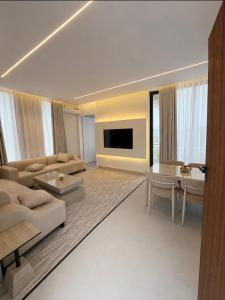 a large living room with a couch and a table at Al Badr Villas Resort in Sawdāʼ