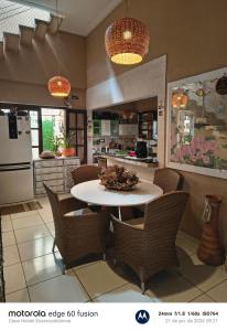 a kitchen with a table and chairs in a kitchen at Casa Hostel Essenza di Donna in São Luís