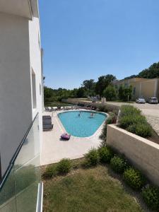 a swimming pool in a yard next to a building at Teracite in Varna City