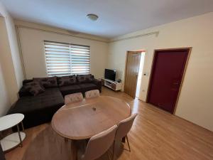 a living room with a couch and a table at STUDIOAPARTMANI JEDVAJ in Krapina