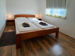 a bedroom with a bed with two shoes on it at Bei Marko in Barić Draga