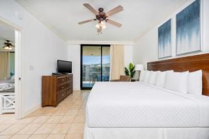 a bedroom with a bed and a ceiling fan at Phoenix on the Bay 1524 in Orange Beach +37 photos
