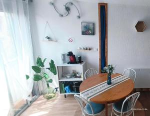a dining room with a wooden table and chairs at Studio 4 personnes au Cap-d'Agde in Agde