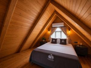 a bedroom with a bed in a attic at Aurora Suit Bungalov in Rize +14 photos