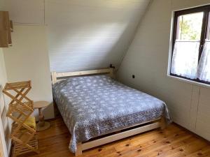 a small bedroom with a bed in a attic at Domek letniskowy Fuleda in Fuleda