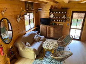 a living room with a couch and a table at Domek letniskowy Fuleda in Fuleda