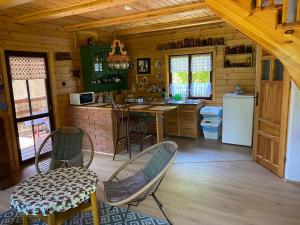 a kitchen with a table and chairs in a cabin at Domek letniskowy Fuleda in Fuleda