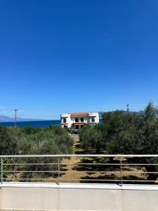 a house on a hill with the ocean in the background at Nōema Residences I in Nafpaktos
