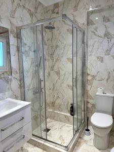 a bathroom with a shower with a toilet and a sink at Nōema Residences I in Nafpaktos +25 photos
