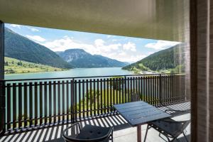 a balcony with a view of a lake and mountains at Residence Froy in Resia