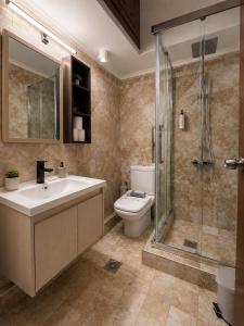 a bathroom with a toilet and a sink and a shower at Kladis Club Holidays in Skala Potamias