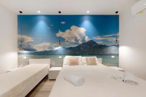 a bedroom with a large bed with a view of the ocean at Appartamenti Villa Andrea in Garda +115 photos