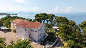 an aerial view of a house and the water at Mare & Mons Seafront Apartments in Malinska