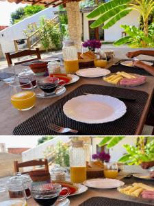 a table with plates of food and glasses of orange juice at Maré alta in Guriú +12 photos