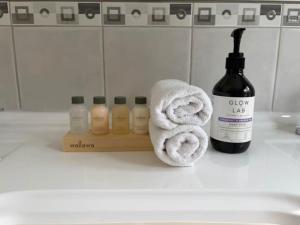 a bathroom counter with towels and a bottle of wine at Kalamata - Adults Only Country Escape in Boyup Brook +8 photos