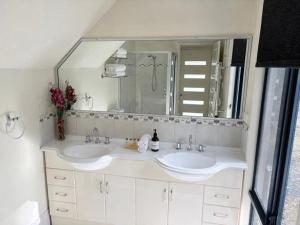 a bathroom with two sinks and a large mirror at Kalamata - Adults Only Country Escape in Boyup Brook