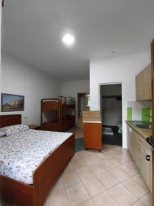 a small bedroom with a bed and a kitchen at Rezidenca Nanaj in Vlorë