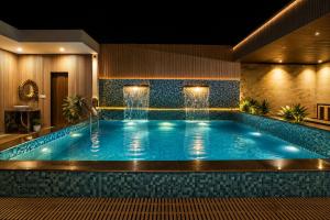 a pool in a hotel room with a swimming pool at Signature StayZ - Amar Singh Palace Near Taj Mahal in Agra