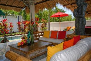 a living room with a couch and a table at Hakuna Matata Bali Villas in Uluwatu