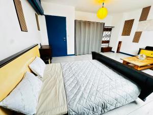 a bedroom with a large bed and a table at Echappée Rétro in Frameries